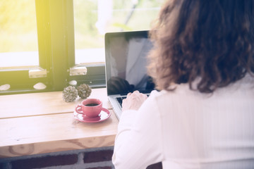 young woman use laptop in coffee shop