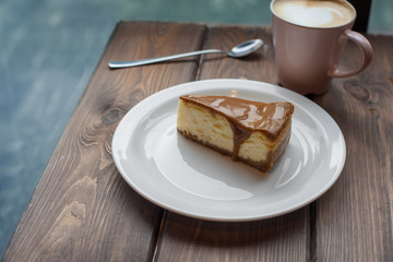 Fancy caramel cheesecake on table flat lay