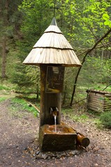 Man made water pump of wood.