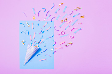 birthday hat with confetti on paper background
