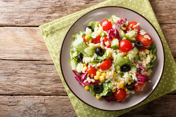Italian vegetable salad with orozo pasta close-up on a plate. horizontal top view from above