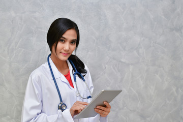 Doctor Concept. Smiling doctor posing in the office. Young doctor is wearing a stethoscope. medical staff on the hospital background. The doctors are happy to work.