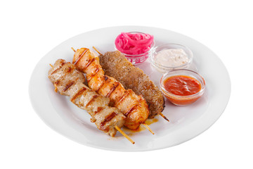 Shish kebab, beef, lamb, pork, chicken meat on the grill, barbecue, without garnish on a plate, isolated on white background. Marinated onion, mayonnaise, tar tar, ketchup, tomato sauce Side view