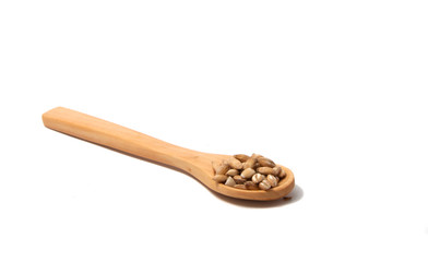 Wooden spoon with grain on the white