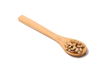 Wooden spoon with grain on the white