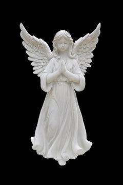Angel statues isolated on black background.