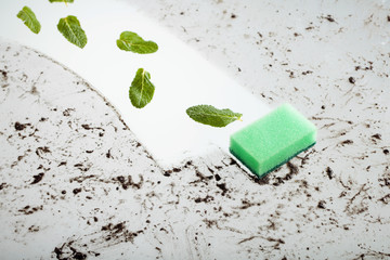 Dirty glass and a sponge .