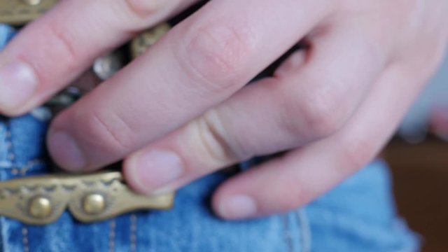 fastening the belt on trousers, decorative buckle
