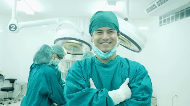 Male doctor looking to camera with smiling at operation room. Healthcare and Medical concept. 
