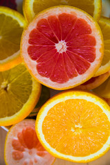 Fototapeta na wymiar Grapefruit and orange slices. Fruit summer background. Vertical shot