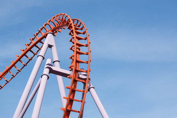 Roller coaster on blue sky background.