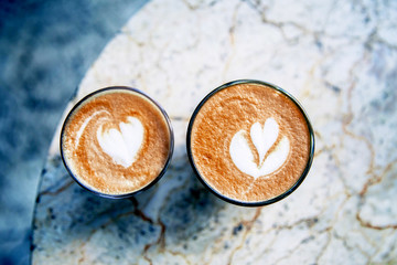 Fototapeta na wymiar Cup of hot latte coffee on marble table background