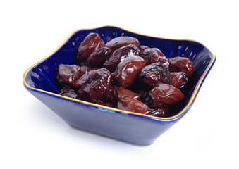 Sun-dried olives with oil and herbs. Isolated