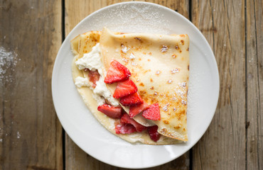 Homemade pancake with fresh ricotta cheese and strawberries