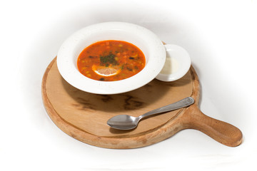 Red soup with lemon on white background