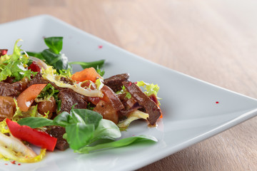 beef slices in spicy sauce with vegetables, Peking cabbage and corn salad