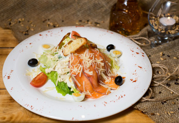 Vegetable salad fish on a white plate