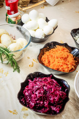 preparing russian traditional salad 'herring under fur coat'