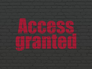 Safety concept: Painted red text Access Granted on Black Brick wall background