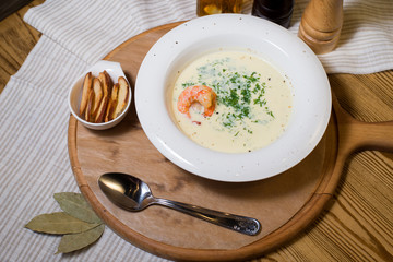 Soup Cream Shrimp on a White Plate on a Tree