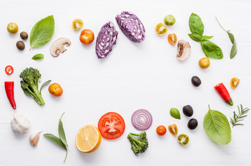Various fresh vegetables and herbs on white background.Ingredients for cooking concept sweet basil ,tomato ,garlic ,pepper and onion with flat lay..