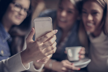 Self portrait of young three girls. Focus is on hand.