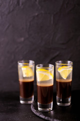 Alcoholic cocktail silver bullet with gin, coffee liqueur and lemon.