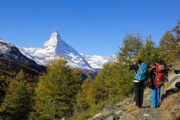 Fototapeta na wymiar Hiker are photographing Matterhorn, the famous Alps peak in Switzerland