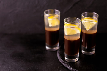Alcoholic cocktail silver bullet with gin, coffee liqueur and lemon.