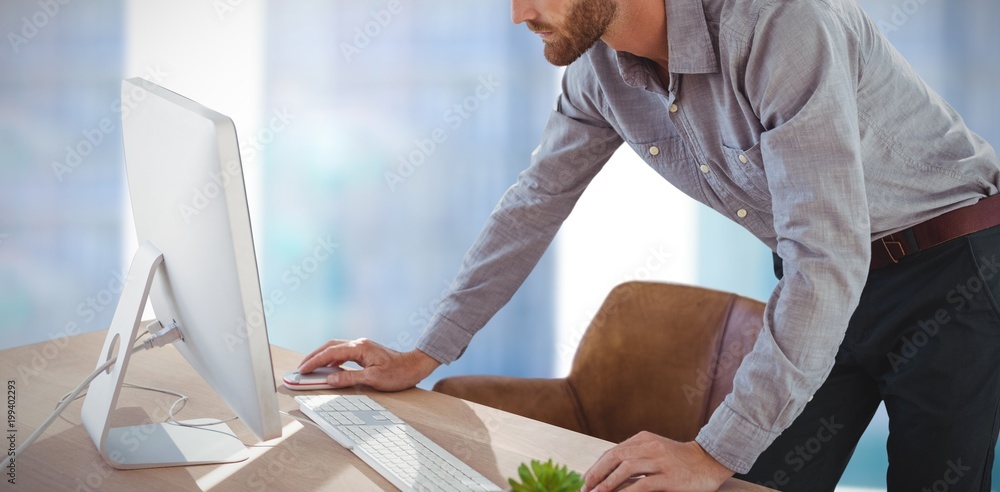 Poster composite image of businessman using computer while standing at