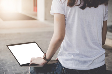 Young woman using laptop computer. Student girl working on laptop outdoor