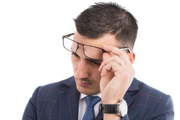 Young bussinessman adjusting glasses on forehead.
