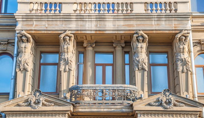 ancient building with beautiful balcony decorated with statues of Atlantis