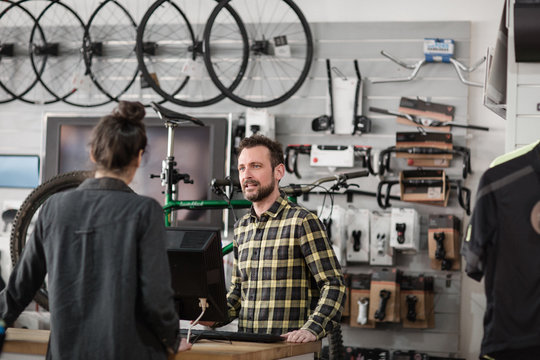 Small business owner serving customer in a bicycle store