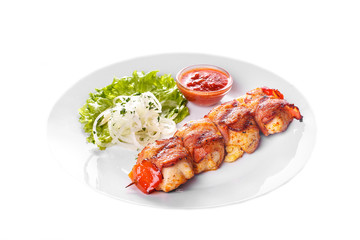Shish kebab, beef, lamb, pork, chicken in bacon grilled meat, barbecue, without garnish on a plate, isolated on white background. Marinated onion, ketchup, tomato red sauce. Side view For the menu