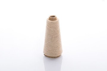 bobbins of the natural fiber, rough flax, isolated on white background