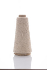 bobbins of the natural fiber, rough flax, isolated on white background