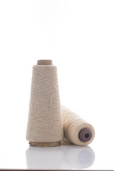 bobbins of the natural fiber, rough flax, isolated on white background