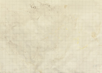 An old piece of squared paper; a vintage yellowed texture surface full of dust and small stains.
