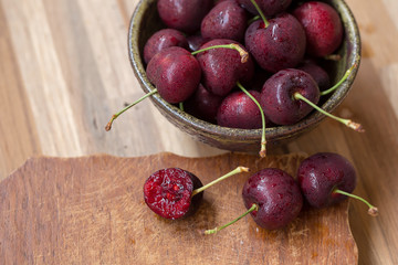 Bowl of Cherries. Red cherries in a bowl on wooden background