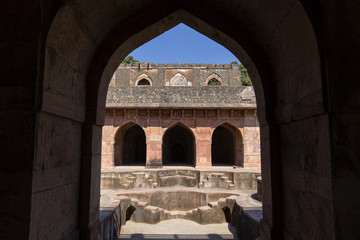 Ancient fort ruined city at Mandu, Madhya Pradesh, India. Arched architecture in the palace Jahaz Mahal