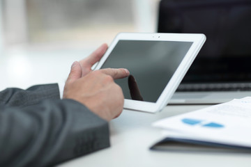 closeup.successful businessman working with tablet computer