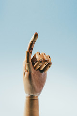 close up view of wooden puppet hand isolated on blue