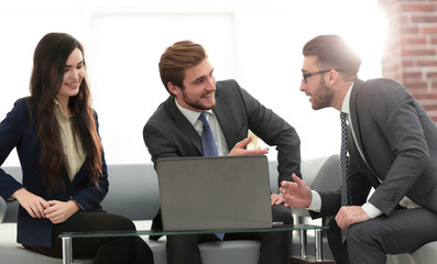 A business team of three planning work in office.