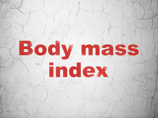 Medicine concept: Red Body Mass Index on textured concrete wall background