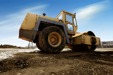 Vibratory soil compactor working on highway construction site