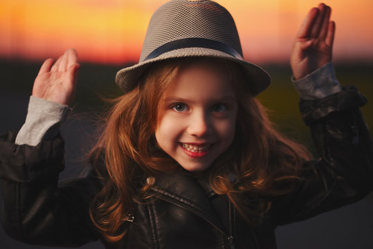 beautiful girl with hat on evening sunset