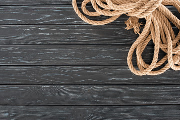top view of brown rope on dark wooden surface