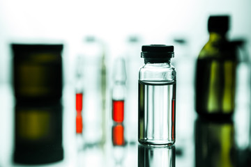 Group object of liquid medicinal agent in limpid glassware in medical laboratory. Group of ampoules with a transparent medicine in medical laboratory