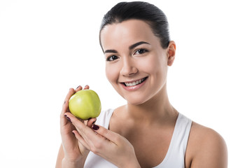 smiling beautiful girl holding ripe apple isolated on white